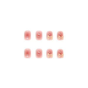Pink gradient press-on nails with 3D crystal bows and glossy blush finish