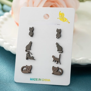 Asymmetric stainless steel cat stud earring set with four pairs of black feline silhouettes