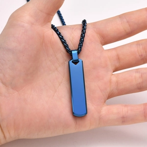 Close-up of a blue stainless steel rectangular pendant on a braided chain necklace