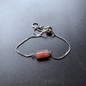 Silver box chain bracelet with a cylindrical pink-orange natural crystal stone bead
