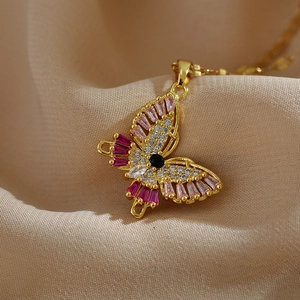 Exquisite gold butterfly necklace with colorful zircon stones on champagne silk fabric