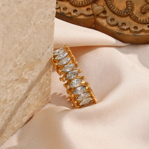 Detailed close-up of a gold-plated ring featuring marquise-cut zircons in a full eternity band