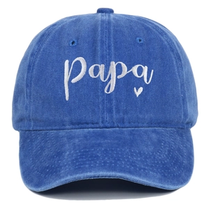 Macro detail of white Papa heart embroidery on blue washed cotton baseball cap
