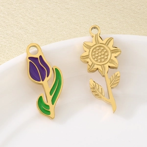 Enameled tulip and golden sunflower stainless steel pendants in a ceramic plate