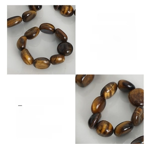 Detail of tiger eye stone bead ring with 18K gold plated steel and elastic cord