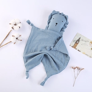 Close-up of a blue cotton gauze lion security blanket with soft knotted corners