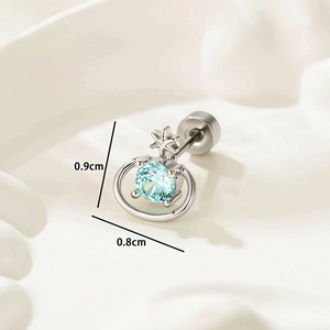 Silver Saturn earring with light blue zircon and star detail on white background