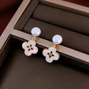 Elegant 18k gold plated clover earrings with mother of pearl and pearls on jewelry box