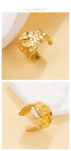 Macro detail of 18K gold plated U-shaped ear cuff featuring irregular lava texture
