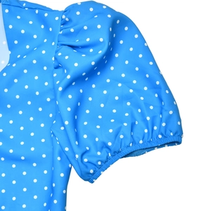Detail of blue polka dot summer dress showing short puff sleeves with elastic cuffs