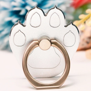 Detail of bear paw metal phone ring holder featuring silver base and gold rotating ring