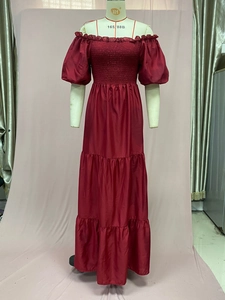 Detail of burgundy off-shoulder tiered maxi dress with puff sleeves on mannequin