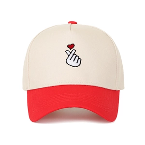 Two-tone baseball cap in beige and red featuring a heart gesture embroidery detail