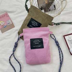 Close-up of corduroy crossbody phone bags in purple and olive with braided rope