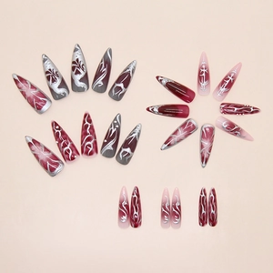 Macro detail of dark red marble nails with silver 3D liquid metal textured lines