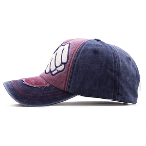 Close-up of distressed brim details and embroidered fist logo on washed cotton baseball cap