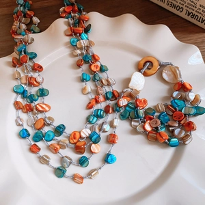 Multilayer shell bead necklace and bracelet set in vibrant orange and blue tones