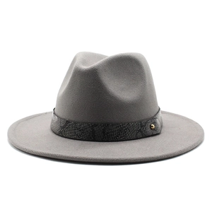 Detail of light gray fedora hat featuring a snakeskin pattern band and gold stud accent