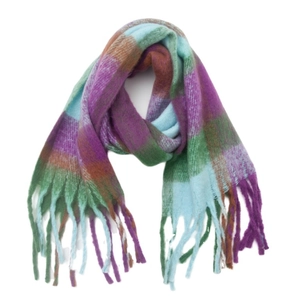 Macro shot of fluffy plaid winter scarf texture with colorful tassels in purple and green