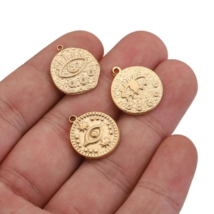 Handheld view of gold stainless steel irregular round evil eye pendants for DIY jewelry