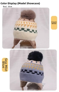 Detail view of jacquard knit earflaps beanies in cream white and sea mist blue colors