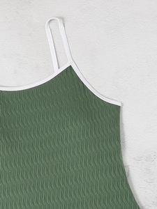 Detail of moss green swimwear fabric with 3D ripple texture and white contrast piping