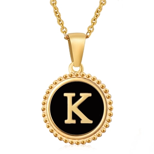 18K gold plated necklace with round black shell pendant and gold letter K detail