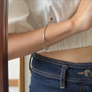 Minimalist S925 sterling silver Mobius twist cuff bracelet on a woman wrist