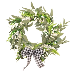 Artificial wreath with white berries, eucalyptus leaves and a black-white plaid bow