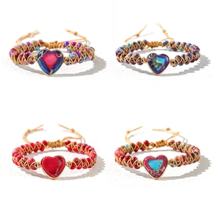 Detailed view of four handmade woven heart-shaped natural stone bracelets with adjustable cords