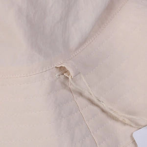 Detail of water-resistant nylon sun hat featuring multi-row stitching and a wind cord loop