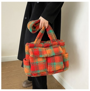 Close-up of plush tote bag featuring a vibrant red, green, and orange checkered pattern