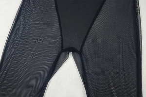 Close-up of black sheer mesh fabric and seam construction on a slim fit bodysuit
