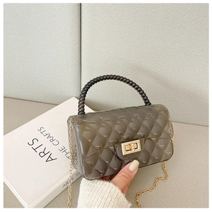 Detailed view of the smoky gray jelly bag with diamond lattice pattern and bead handle