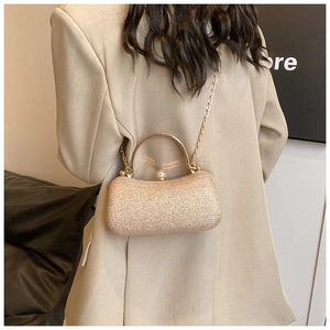 Detail of champagne gold evening bag with sequin texture and sparkling diamond clasp
