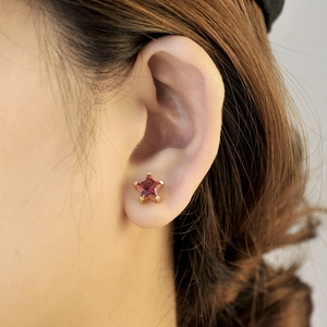 Minimalist S925 star stud earrings with pink zircon stone on model in golden finish