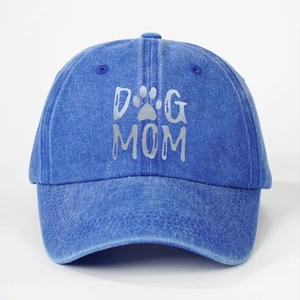 Detailed view of DOG MOM print and paw icon on washed denim baseball cap