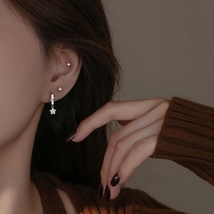 Elegant S999 sterling silver star stud earrings with cubic zirconia on female model
