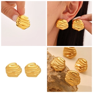 Detailed views of gold uneven ripple earrings with polished metallic texture and 3D design