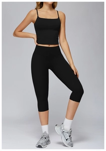 Close-up of black yoga set featuring square neck crop top and high-waist capri leggings