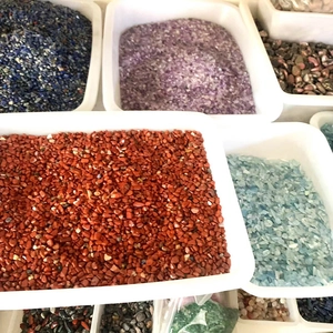 Detailed macro view of assorted natural colorful crystal gravel in white plastic trays