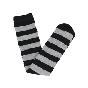 Detailed knit texture of black and grey striped knee high socks in a flat lay view