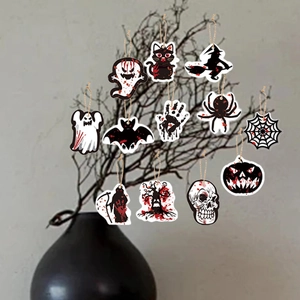 Detailed view of 12-piece Halloween hanging tags with ghost and bat designs on a branch