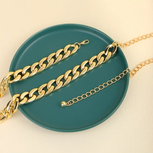 Detail of chunky gold acrylic waist chain with adjustable lobster clasp on display