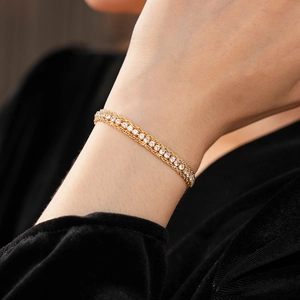 Macro shot of 18K gold-plated triple-layer chain bracelet with sparkling zircon inlay