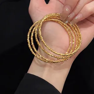Elegant five-layer gold plated beaded bangle bracelet set with shimmering metallic finish