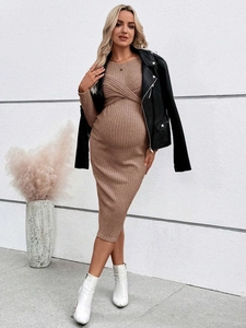 Brown ribbed knit maternity dress with twist-front detail and long sleeves on model