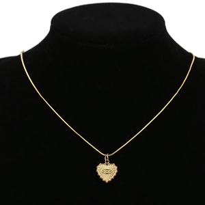 18k gold heart pendant necklace with evil eye embossing on a black velvet mannequin