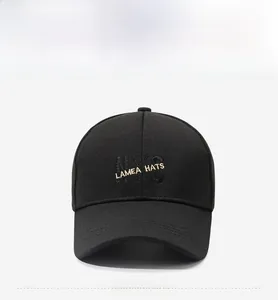 Macro detail of golden LAMEA HATS 3D embroidery on black textured baseball cap