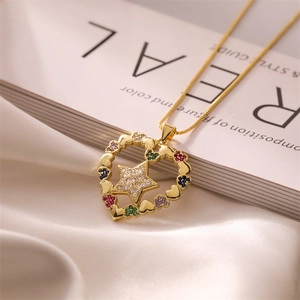 Detail view of heart pendant necklace with star and colorful zircon on white silk